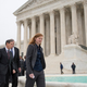 Abigail Fisher, who challenged the use of race in college admissions, walks with lawyers Edward Blum, left, and Bert Rein, rear, outside the Supreme Court in Washington, Wednesday, Dec. 9, 2015, following oral arguments in the Supreme Court in a case that could cut back on or even eliminate affirmative action in higher education.